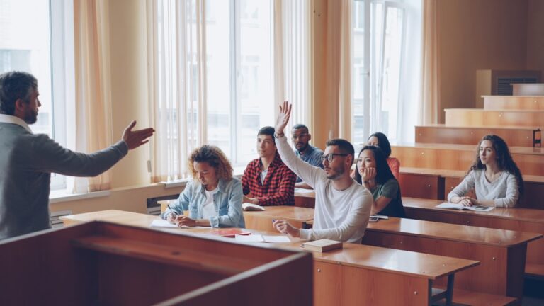 Students raising hands in ESL differentiated instruction classroom