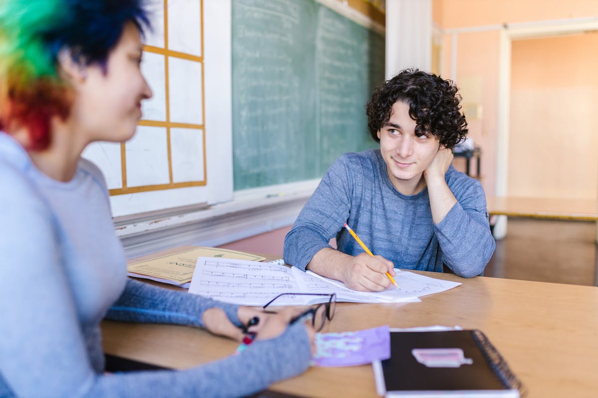 Two ESL students practicing pair work speaking activities in the classroom