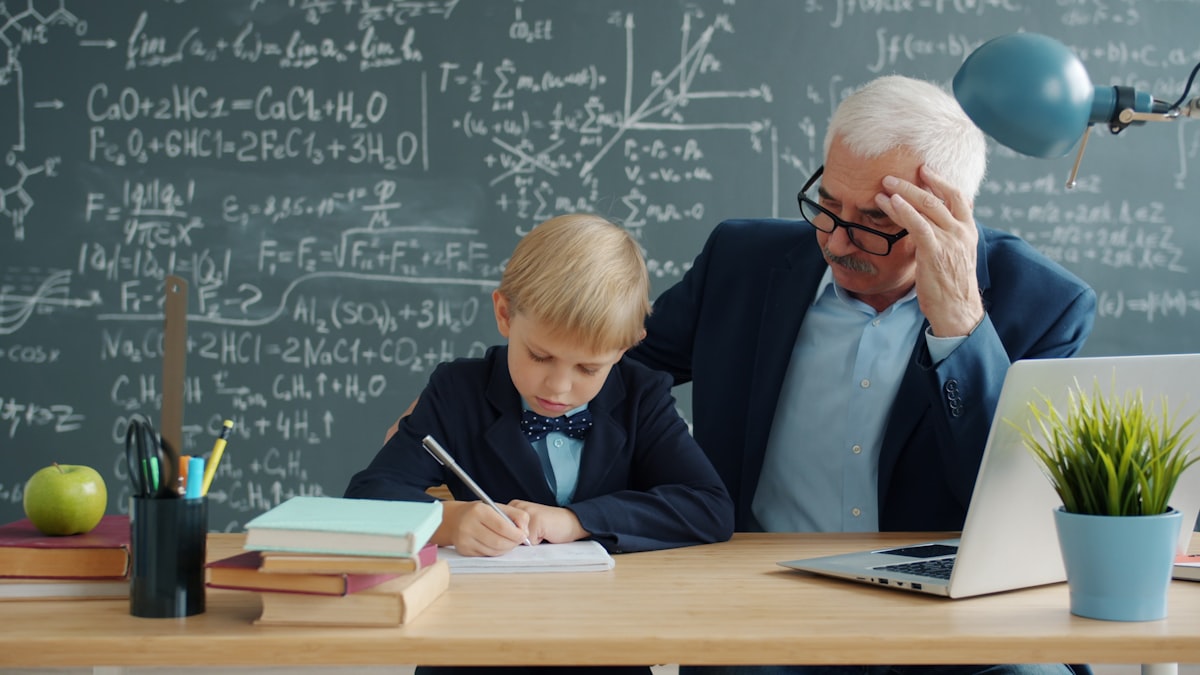 ESL teacher helping individual student at their desk with English language work