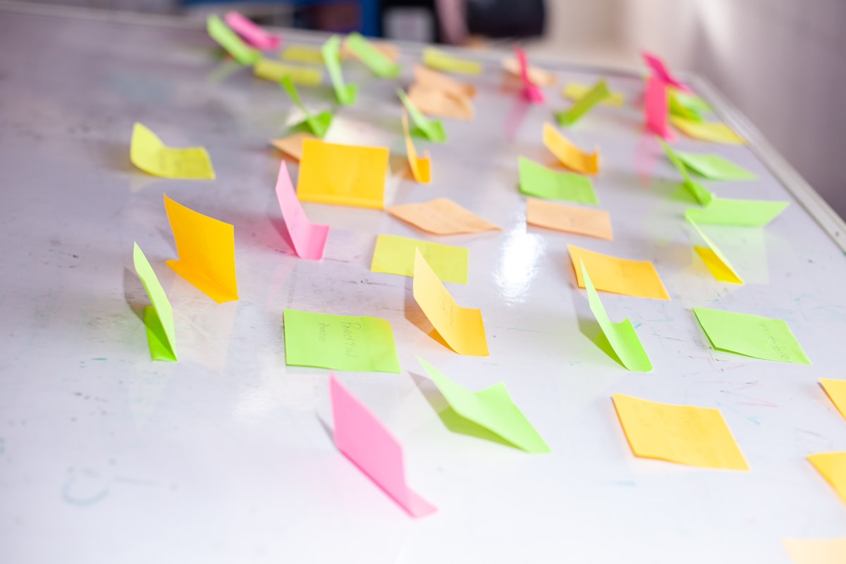 Colorful sticky notes on a board used for brainstorming ESL writing ideas