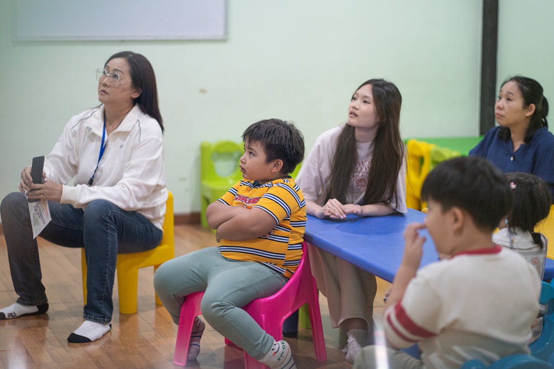 Mixed-age classroom setting with adults and children practicing listening comprehension