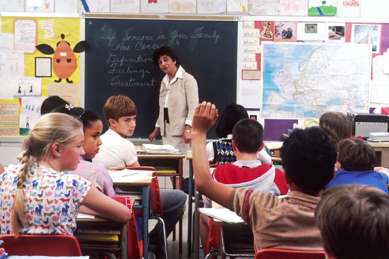 ESL teacher standing in front of young students during a pronunciation lesson