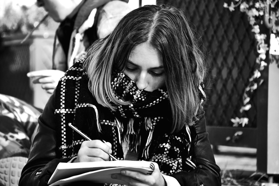 ESL student writing in notebook during differentiated writing task