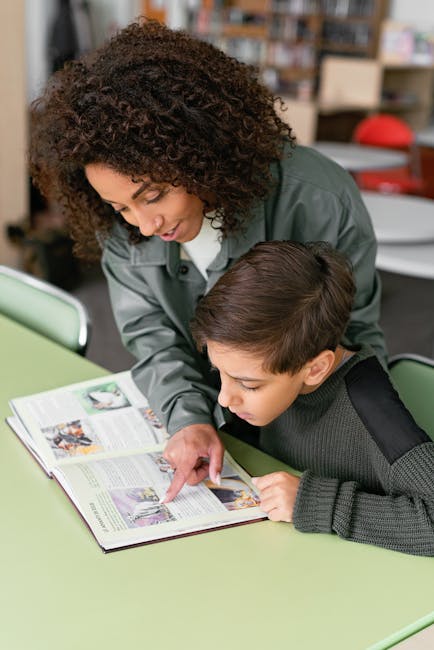 Teacher helping ESL student with reading comprehension at a desk