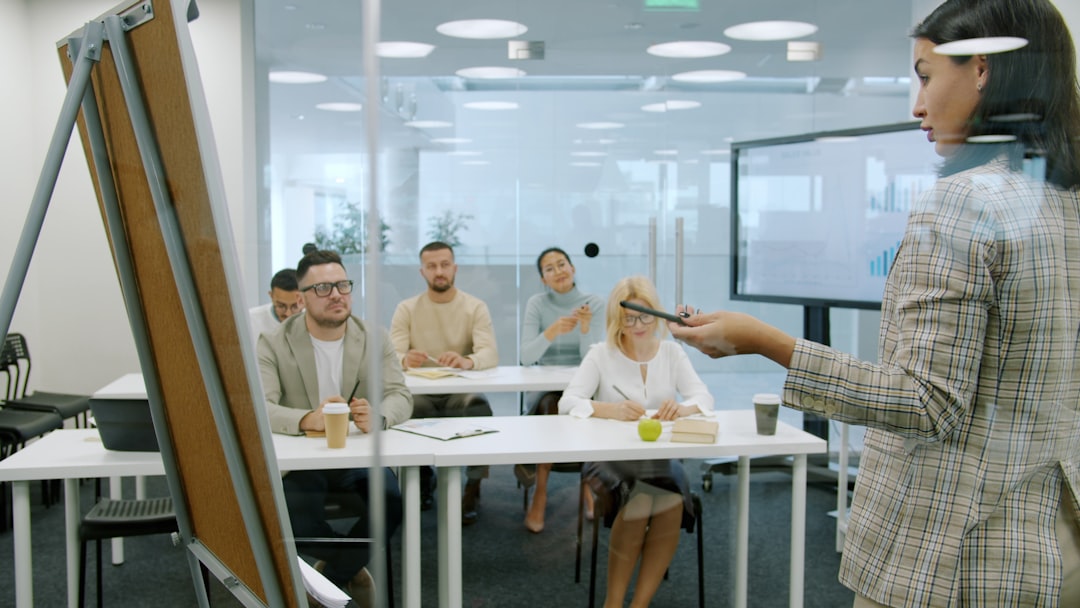 Managers men and women are listening to employee young lady making report in conference room talking and gesturing using flip