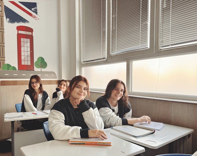 Group of students in a classroom with British decor, studying near a large window.
