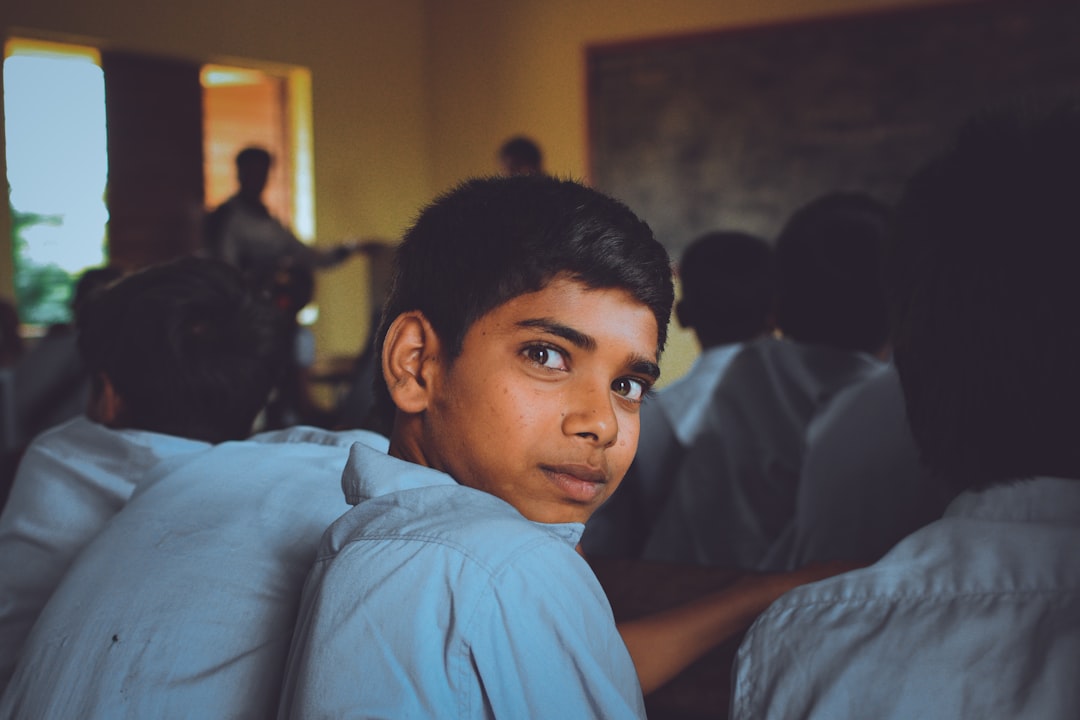 A young Indian student looking with a spark in his eyes, aiming towards a bright future for himself and for India.