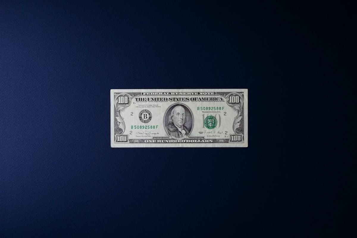 English idioms about money featured image showing dollar bills and coins