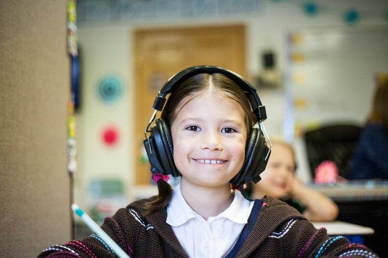 Young learner with headphones doing ESL listening game