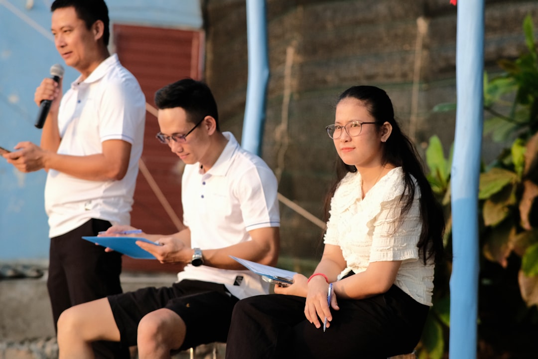 a man and a woman sitting on a bench with a microphone