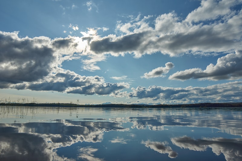 Blue sky over lake symbolizing under the weather and weather idioms