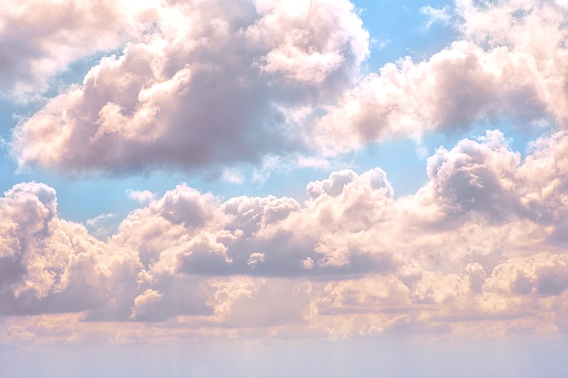 Bright cloudy sky representing head in the clouds idiom meaning