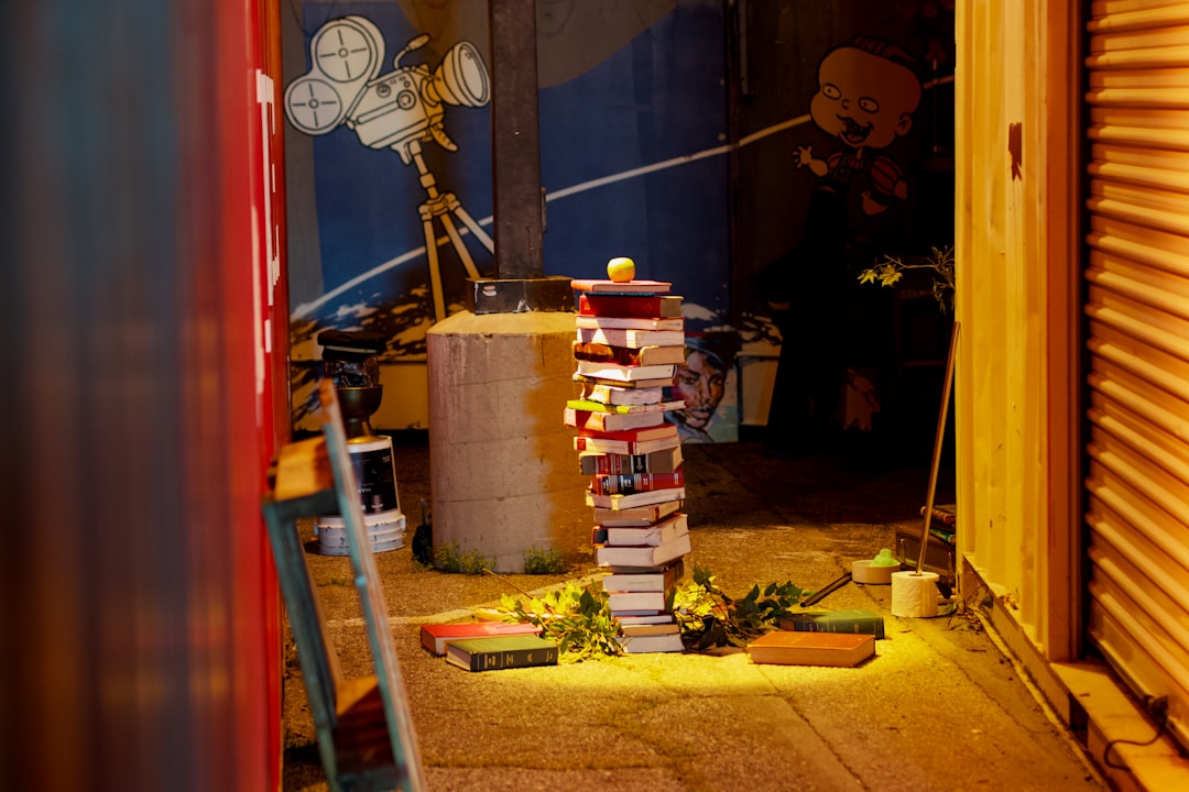 Stack of books in a dimly lit alleyway at night.