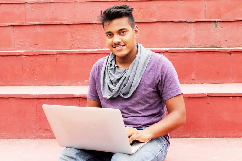 Student writing competition entry and scholarship application on a laptop