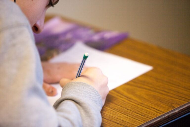 Student writing a scholarship essay for study abroad
