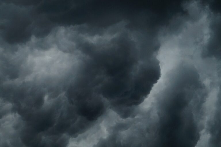 Weather idioms in English illustrated by stormy sky and clouds