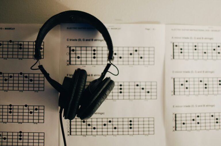 ESL songs classroom — headphones over guitar chord charts