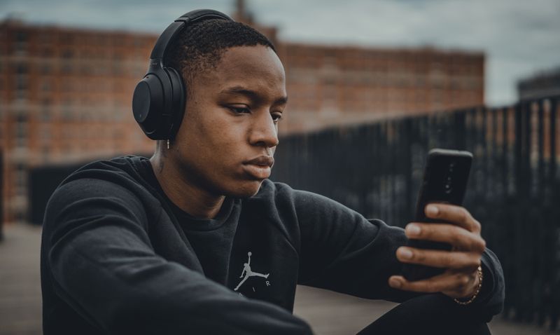 ESL songs student listening on a smartphone