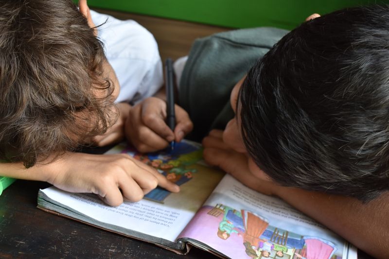 ESL students working in pairs on collocations exercises and vocabulary chunks