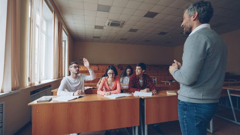 ESL teacher running a warm-up conversation activity with students