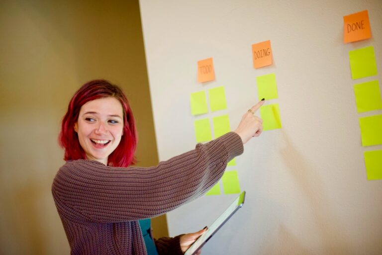 ESL teacher planning a backward design lesson with sticky notes