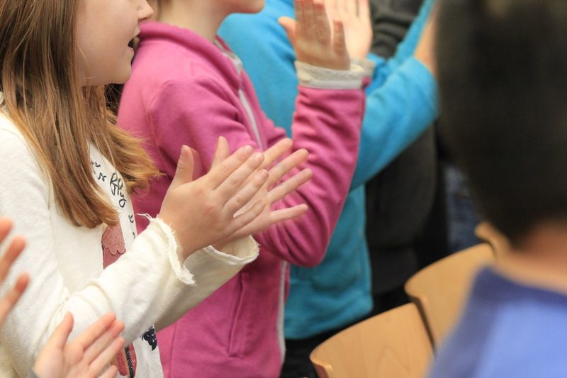 First day ESL activities icebreaker with young learners high-fiving