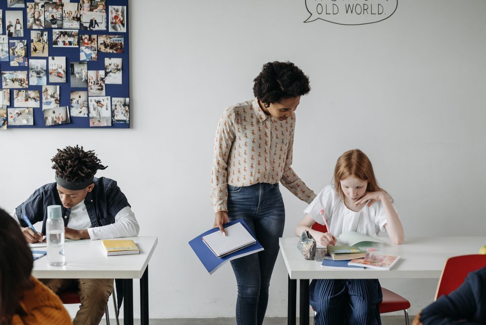 Teacher circulating and monitoring students during a pair speaking activity