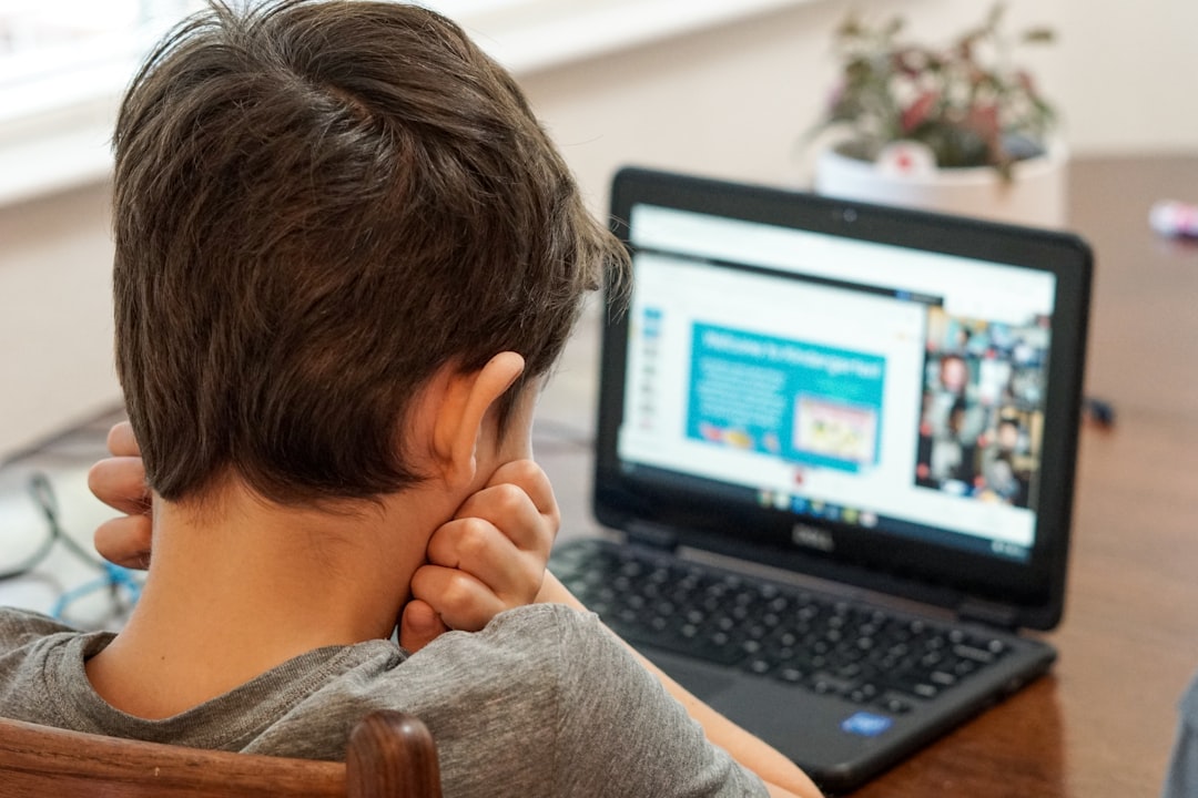 Kindergarten boy looking at laptop computer during first day of virtual learning online school.