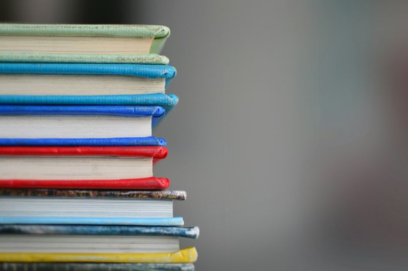 Stack of books representing a minimal pairs consonant sounds list