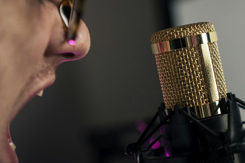 Student doing minimal pairs speaking practice into a microphone