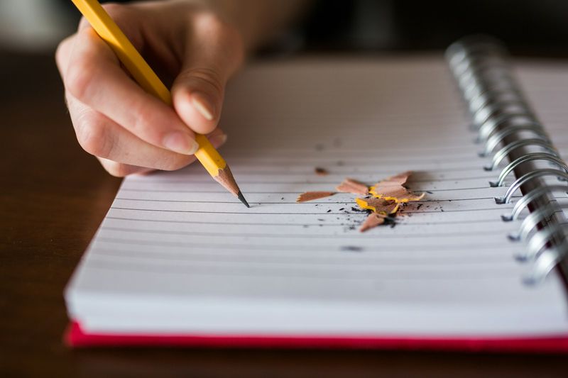Teacher writing reflective teaching notes after a lesson