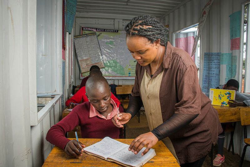 Teacher helping a student understand English tenses