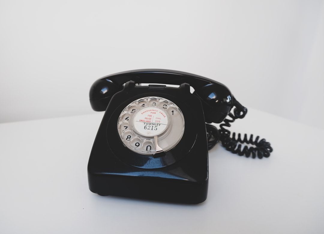 Old fashioned retro styled phone with analogue rotary dial used in the UK.