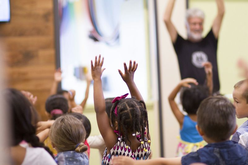 Children doing an action song with total physical response in an ESL class