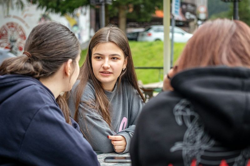 Adult students practicing English conversation together
