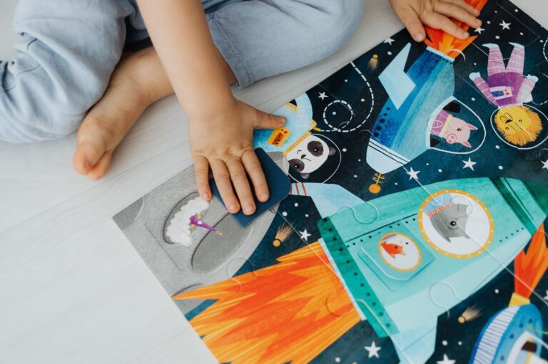 A young child solves a colorful space-themed jigsaw puzzle indoors.