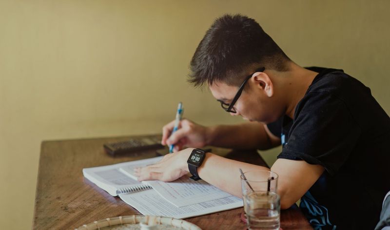 ESL student taking notes while reading for comprehension practice