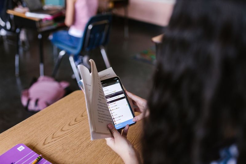ESL student reading at their level in a classroom setting