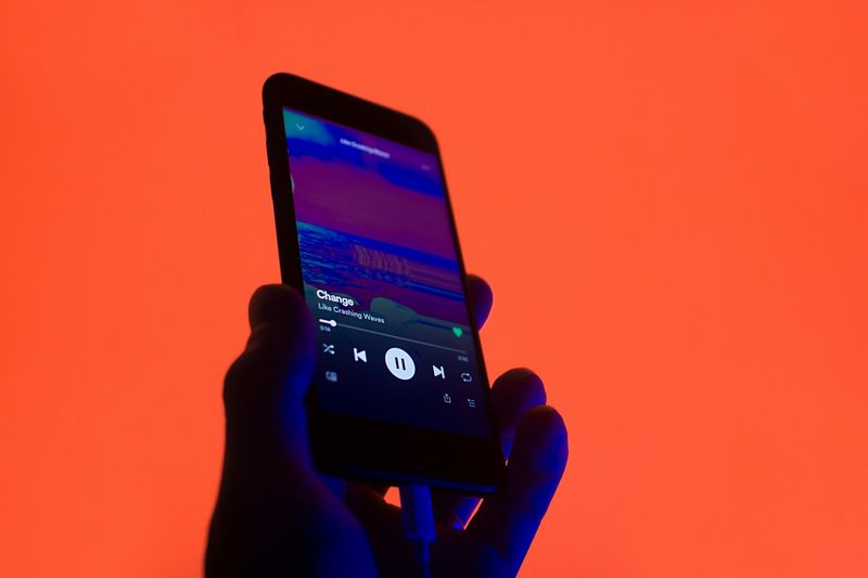 ESL song playlist on a phone for mobile English learning