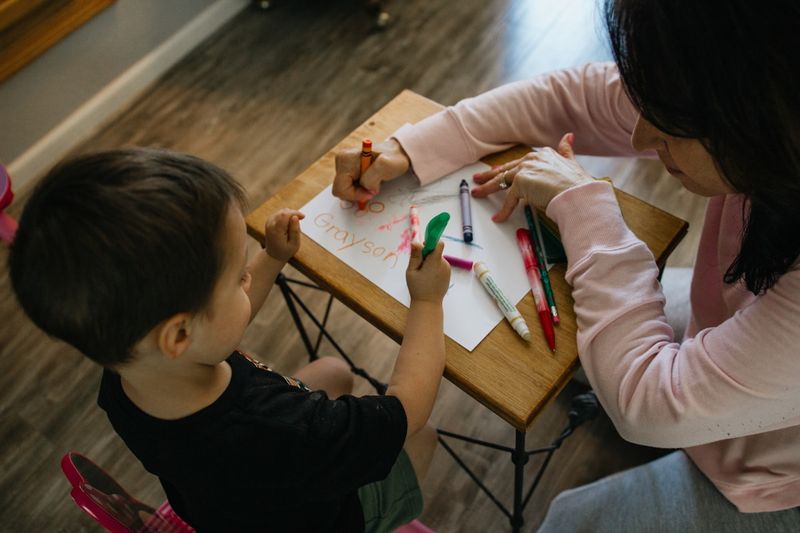 Teacher giving one-on-one corrective feedback to a young learner