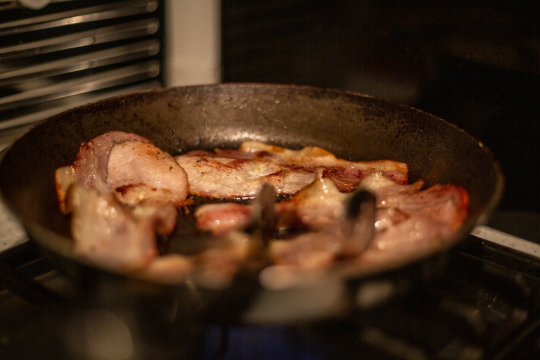 Bacon frying in a pan — bringing home the bacon