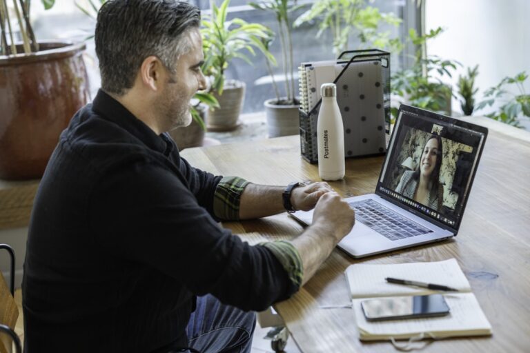 Teacher on a video call teaching English online from a home office