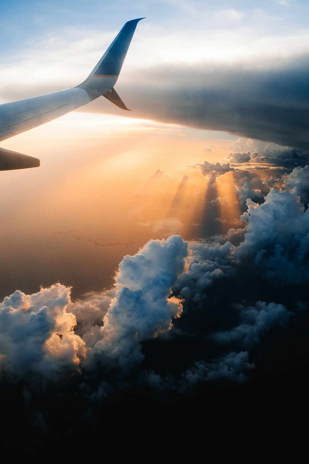 Airplane wing above a golden sea of clouds at sunset, symbolising life's journey Airplane wing above a golden sea of clouds at sunset, symbolising life's journey