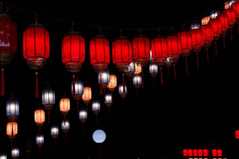 Elegant red and white lanterns illuminate the night in this festive scene.