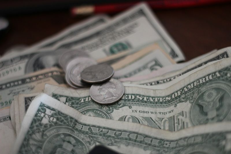 Real money and coins used as realia to teach shopping English in the classroom
