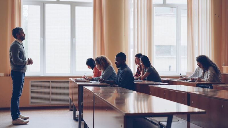 ESL teacher monitoring students to collect errors for correction
