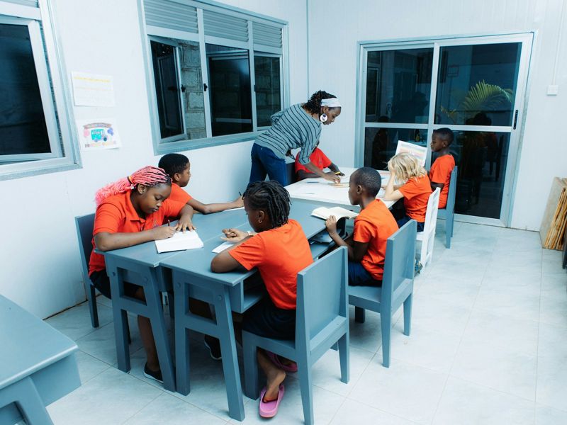 Teacher using realia with young learners in an ESL classroom
