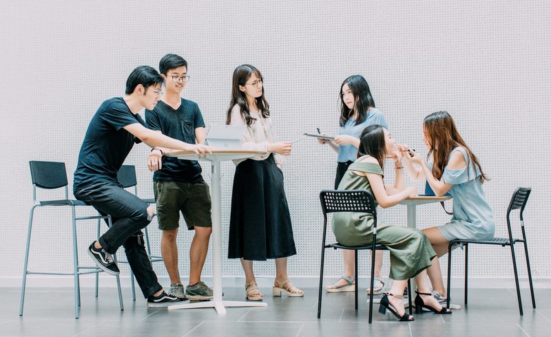 ESL learners doing reported speech pair work at a table