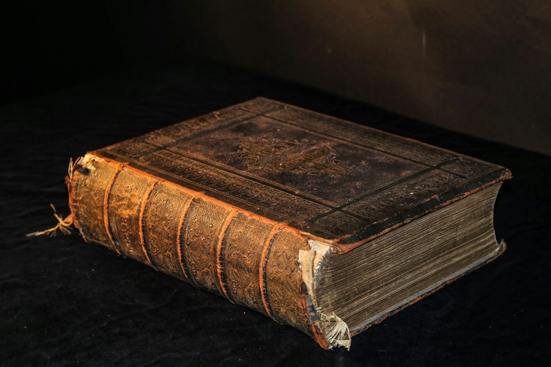 Antique leather-bound book representing Daniel Defoe's classic novel Robinson Crusoe
