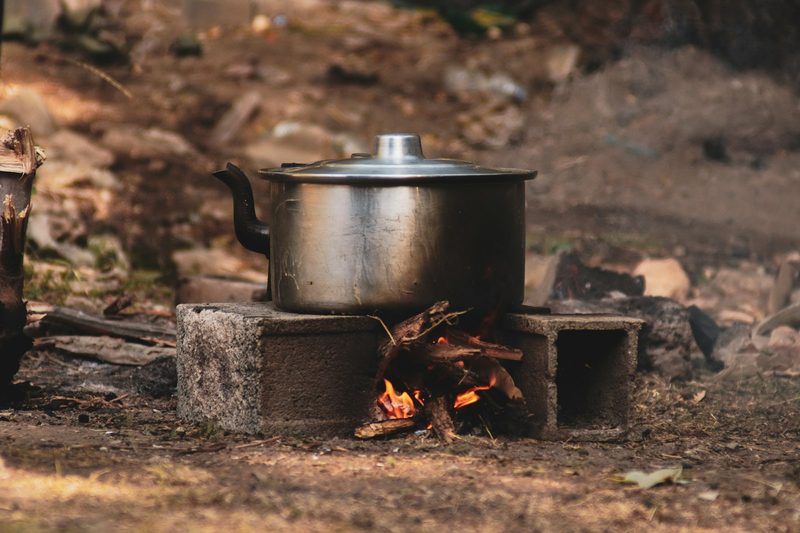 Pot cooking over an open fire, showing the survival skills central to Robinson Crusoe